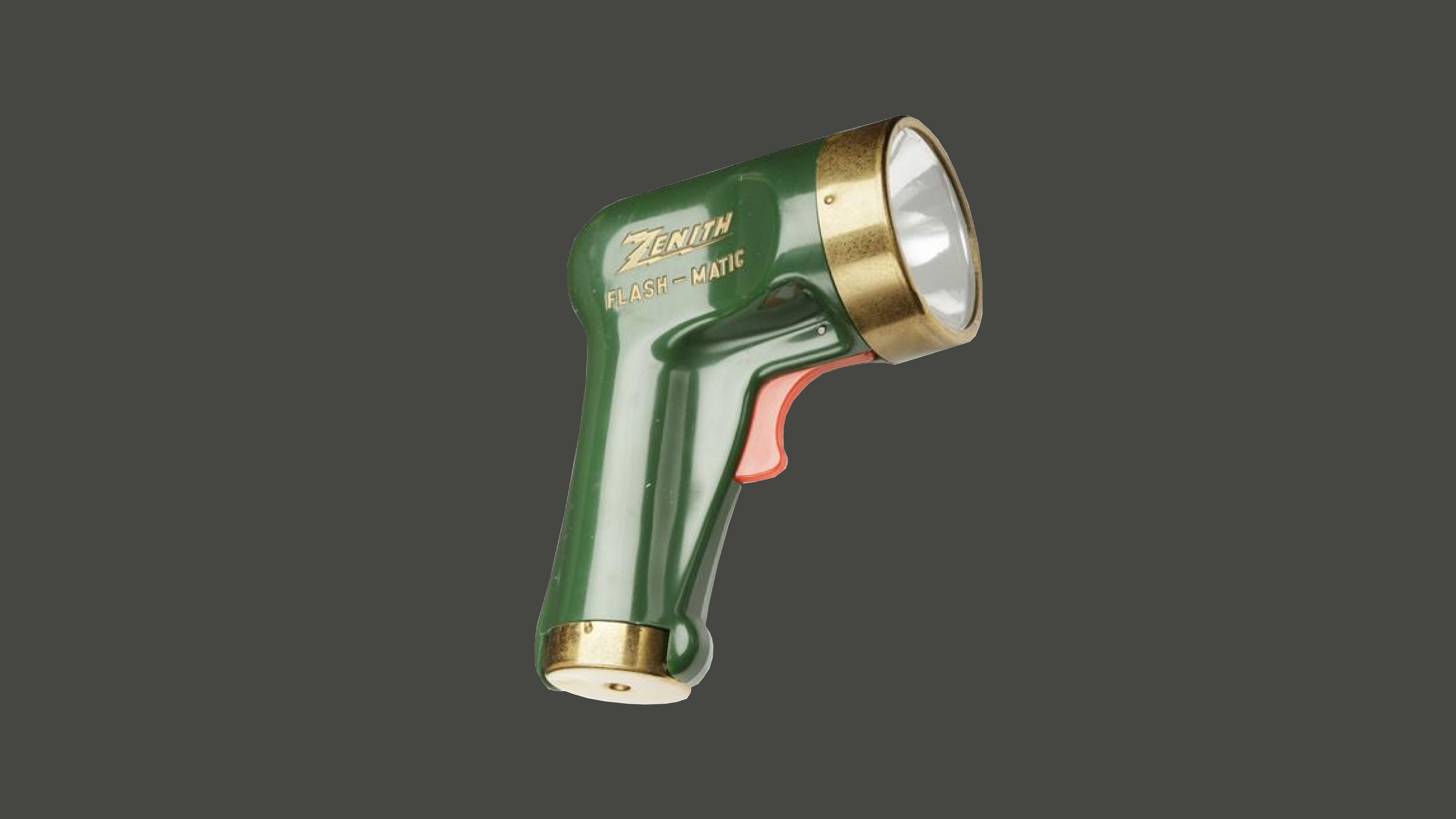 The Zenith Flash-Matic remote, a vintage green and gold device resembling a ray gun, with a trigger-style red button.