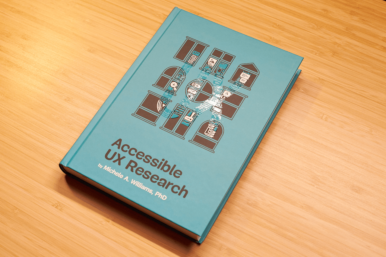 Hardcover edition of Michele Williams’ new book “Accessible UX Research” on a wooden table.