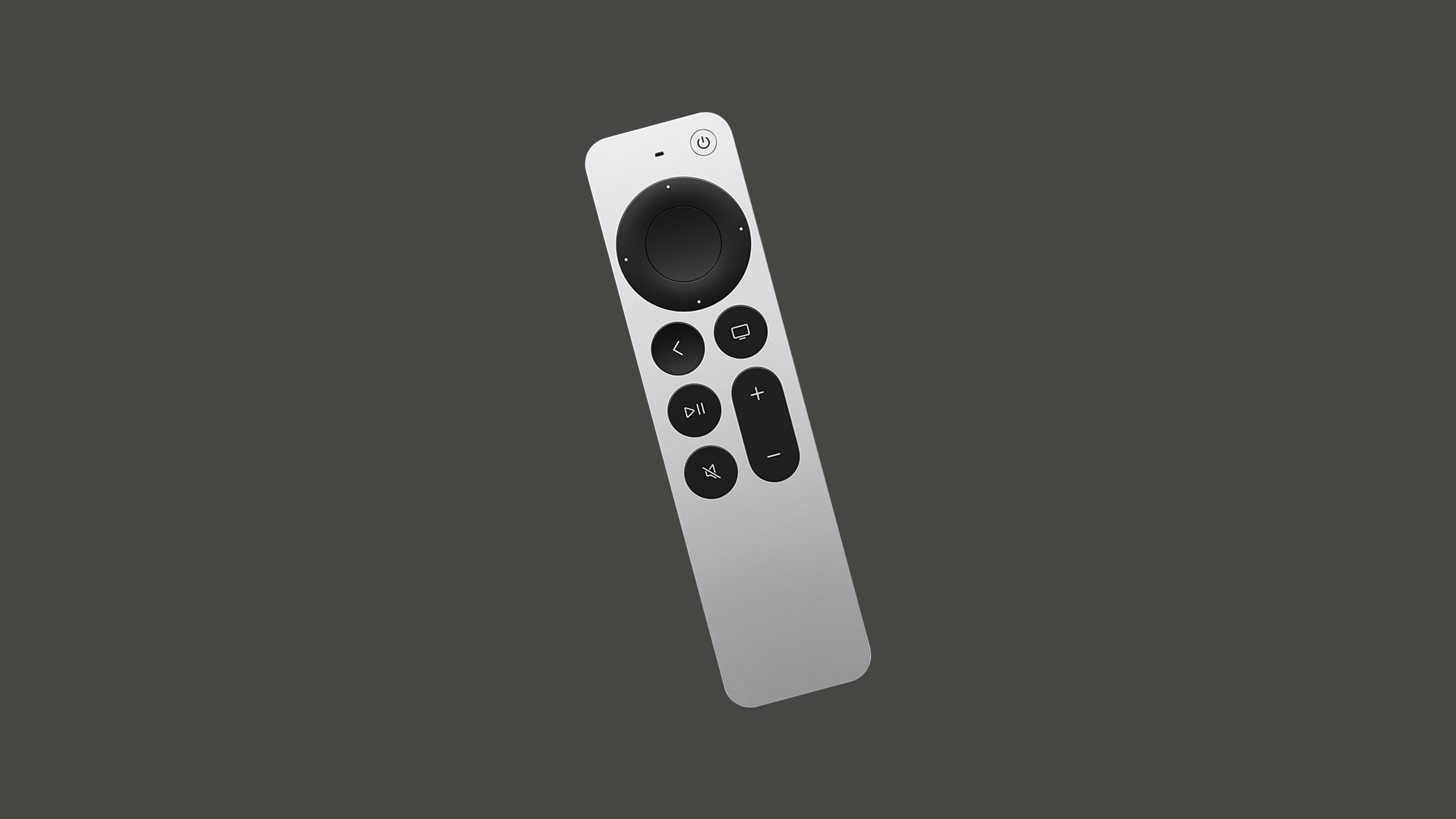 The Apple TV third-generation remote (second-generation Siri remote) featuring a slim, rectangular aluminum body with a silver finish. At the top, a circular black D-pad with a touch-sensitive surface allows both directional button presses and swipe gestures. Below it, a set of black buttons includes back, TV/home, play/pause, mute, volume controls, and a power button.